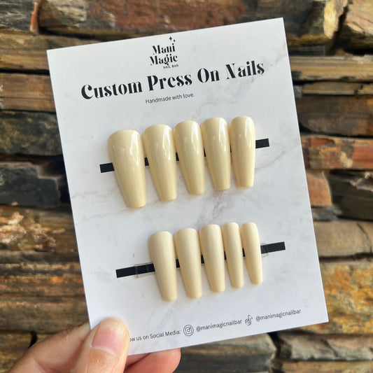 Handmade vanilla cream press on nails displayed on backing card